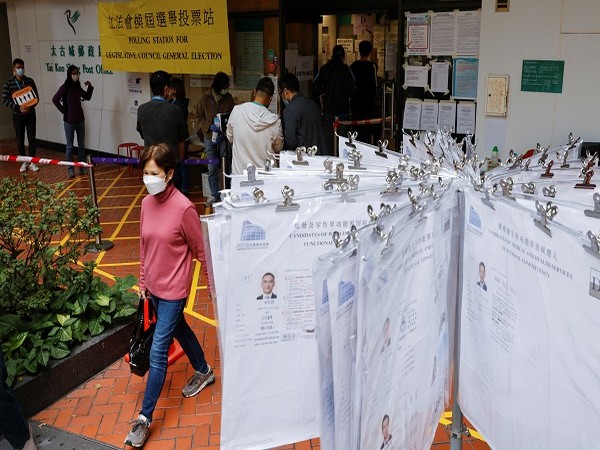 People queue to vote at a polling station during the Legislative Council election in Hong Kong, China, December 19, 2021. (Photo Credit: REUTERS)