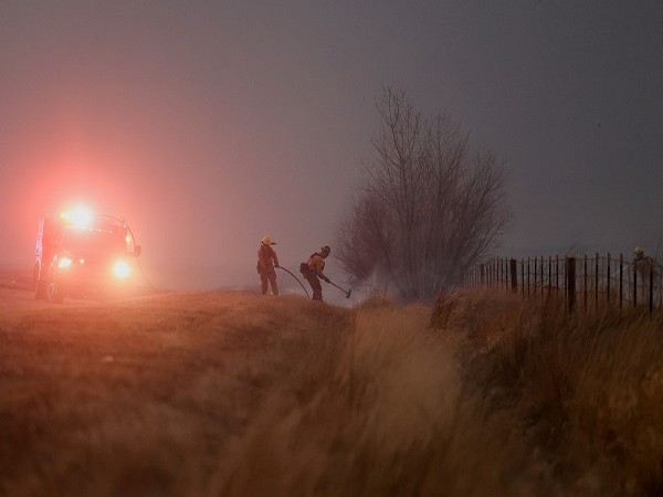 Firefighters work after wind-driven wildfires prompted evacuation orders, near Boulder, Colorado, U.S. December 30. (Photo Credit: Reuters)