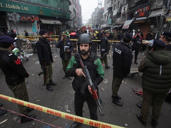 Police officers stand guard inside a cordoned area after a blast in a market, in Lahore, Pakistan January 20. (Photo Credit: Reuters)