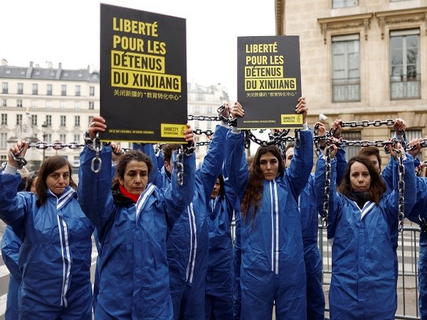 Amnesty International activists take part in protest against China's rights violations in Paris, France, January 26, 2022. (Photo Credit: Reuters)