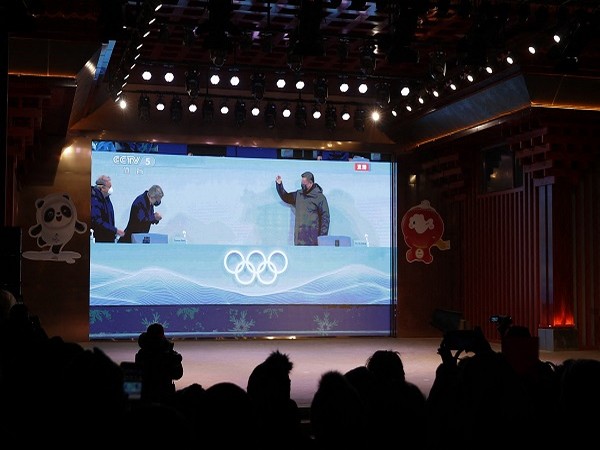 Chinese President Xi Jinping arriving to the Beijing 2022 Winter Olympics opening ceremony are seen on a giant screen broadcasting the ceremony, in Beijing. (Photo Credit: Reuters)
