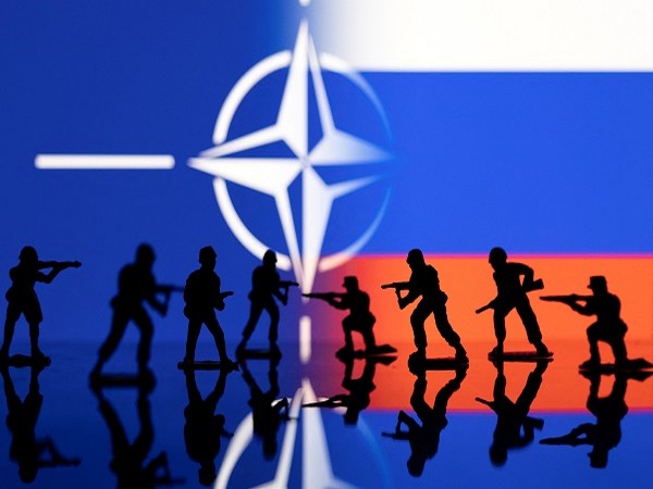 Army soldier figurines are displayed in front of the NATO logo and Russian flag colours background in this illustration taken, February 13. (Photo Credit: Reuters)