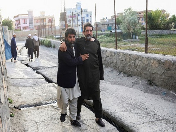 Afghan men flee near the site of explosions at Khalifa Sahib Mosque in Kabul (Photo credits: Reuters)