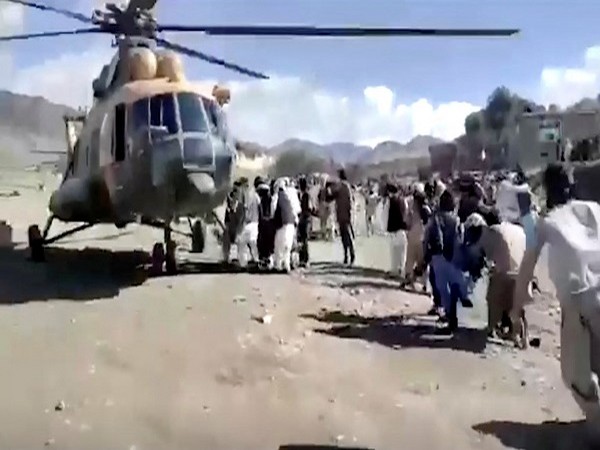 People carry injured to a helicopter following a massive earthquake, in Paktika Province, Afghanistan, June 22, 2022, in this screen grab taken from a video. (Photo Credit: Reuters)