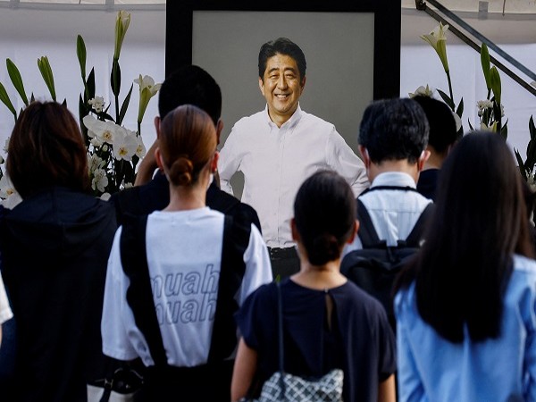 People lay flowers on a flower offering at Abe at Zojoji Temple, where the vigil and funeral of late former Japanese PM Abe, will be held, in Tokyo, Japan. (Photo Credit: Reuters)