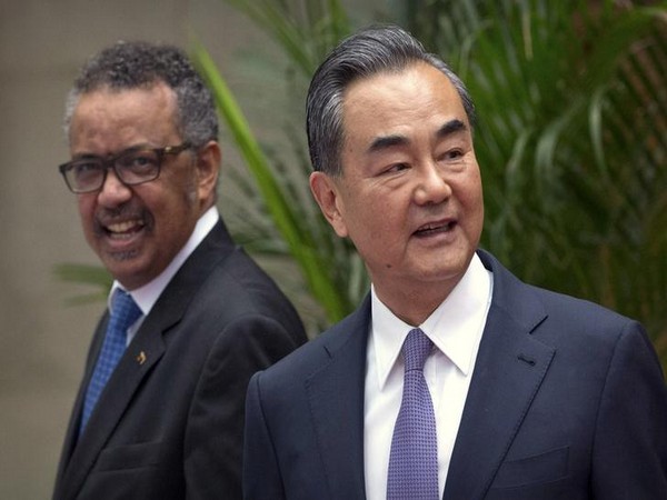 Tedros Adhanom Ghebreyesus, left, Director General of the World Health Organization (WHO), smiles as he arrives for a meeting with Chinese Foreign Minister Wang Yi,
