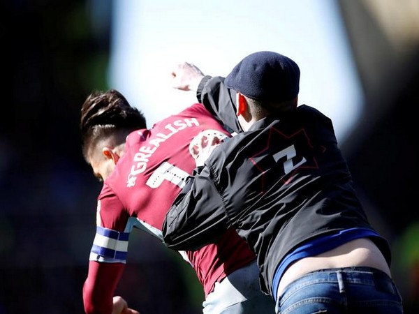 Fan invading the pitch and assaulting Aston Villa's captain Jack Grealish