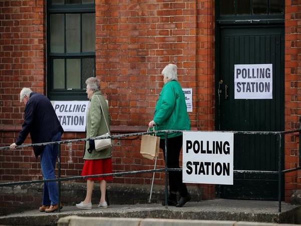 eople leave after voting at a Polling Station in Sale, Britain