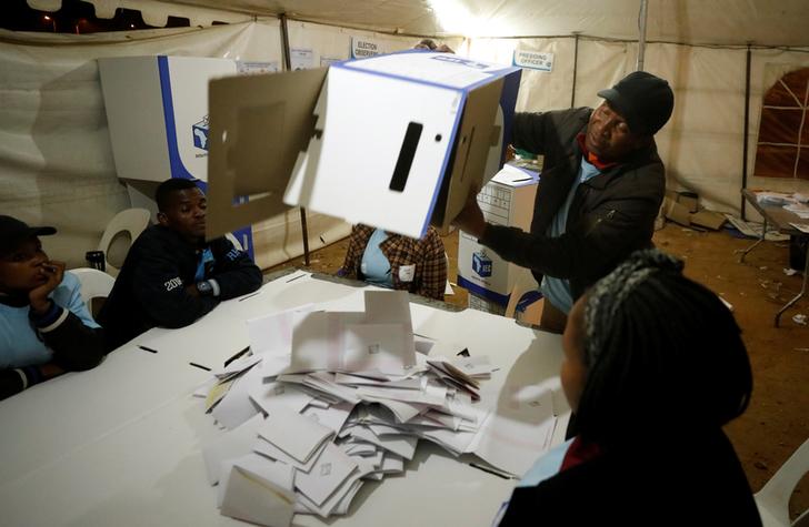 A South African election official empties a ballot box during vote counting in Johannesburg on Friday.