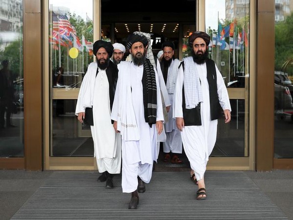 Members of a Taliban delegation, led by chief negotiator Mullah Abdul Ghani Baradar (C front)