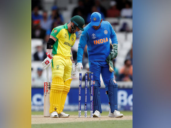 India's MS Dhoni inspecting the bails during a World Cup against Australia