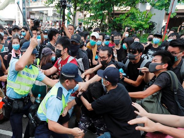 Hong Kong police try to disperse crowd after a protest took place in Sheung Shui, Hong Kong on Saturday.