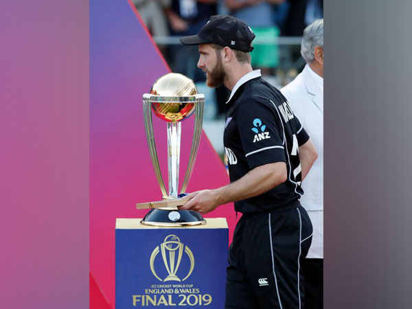 New Zealand's Kane Williamson walking past the World Cup trophy