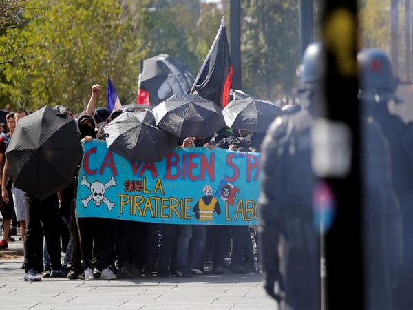 Protesters hold a banner during a demonstration on Act 44 