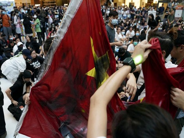 Anti-government protestors vandalise Chinese flag during a rally in Hong Kong on Sunday.