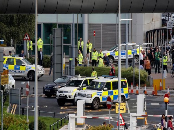 Police officers are seen as a suspect package was found at Manchester Airport, in Manchester, Britain