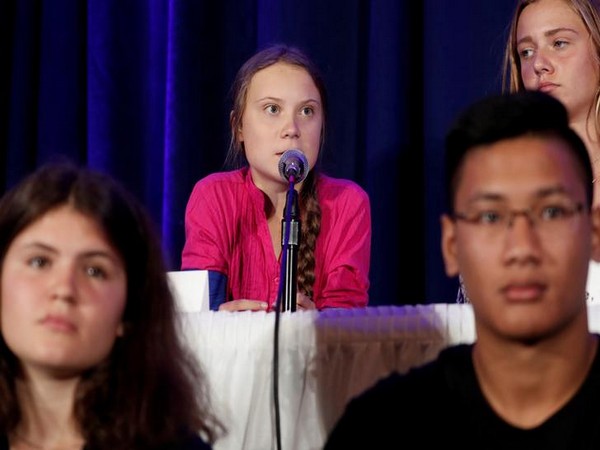 Swedish climate activist Greta Thunberg speaks with other child petitioners from twelve countries