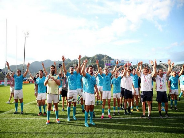 Uruguay players celebrate victory over Fiji in the Rugby World Cup 