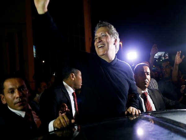 Tunisian presidential candidate Nabil Karoui greets his supporters after he was freed,