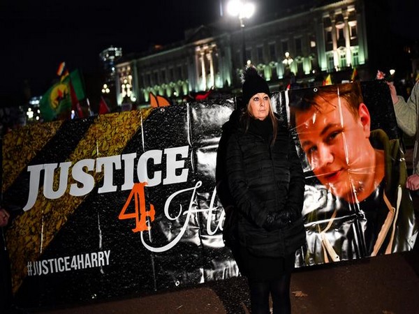Harry Dunn's mother Charlotte Charles poses in front of a banner outside the Buckingham Palace 