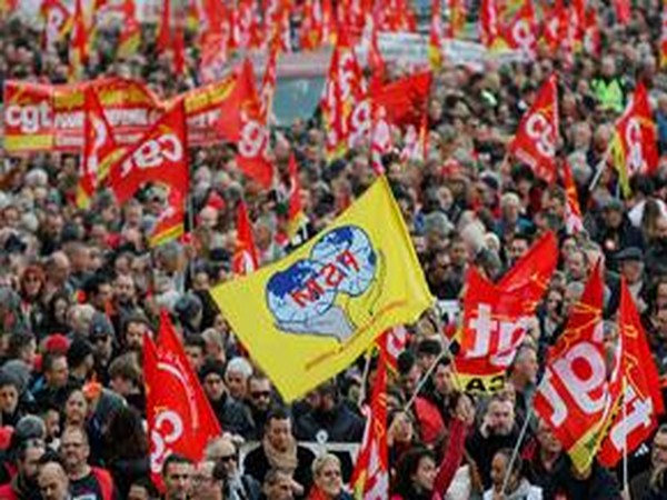 French Labour unions members holding flags attend a demonstration against French government's pensions reform plans in Marseille as part of a day of national strike and protests in France