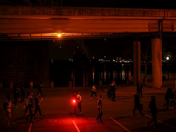 Protesters march after a grand jury considering the killing of a Black medical worker, in her home in Louisville, voted to indict one of three white police officers for wanton endangerment.