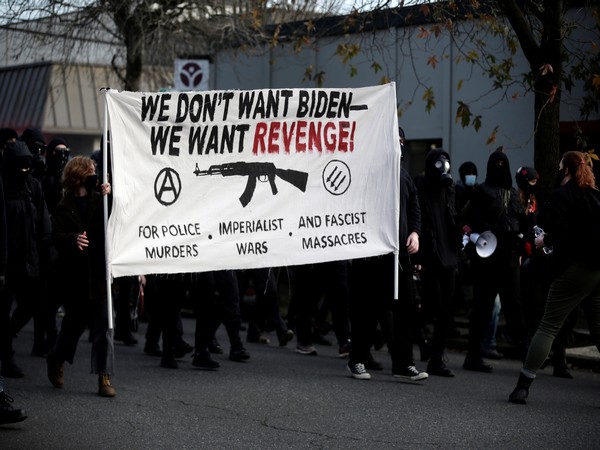 A group of demonstrators in Portland took to streets protesting against newly-sworn-in Joe Biden, police and immigration authorities. (Photo credit: Reuters)