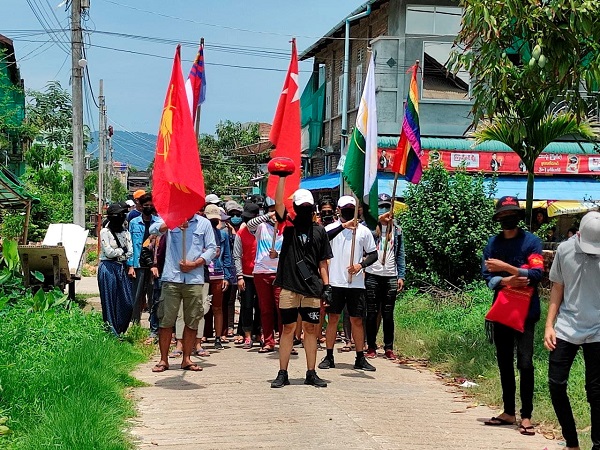 Demonstrators carry flags as they march to protest against the military coup, in Dawei, Myanmar April 27, 2021. (Photo Credit: Reuters)