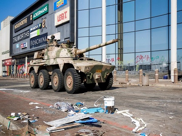    A military tank patrols near a shopping centre that was damaged after several days of looting in Durban, South Africa, July 16, 2021. (Photo Credit: REUTERS)