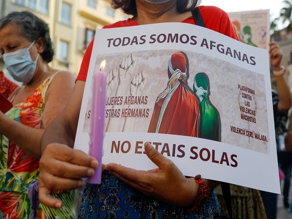 A woman holds a candle in Malaga, Spain August 20, 2021. (Photo Credit: REUTERS/Jon Nazca)