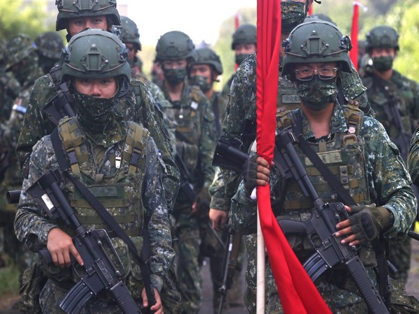 Soldiers march to position during an anti-invasion drill on the beach during the annual Han Kuang military drill in Tainan
