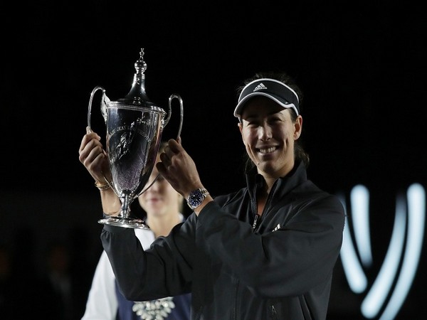 Spain's Garbine Muguruza celebrates with the trophy after winning her final match against Estonia's Anett Kontaveit