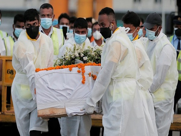 Airport staff carry coffin with remains of Priyantha Kumara, who was beaten to death by the mob in Pakistan, at Bandaranaike International Airport, in Katunayake, Sri Lanka. (Photo Credit: Reuters)