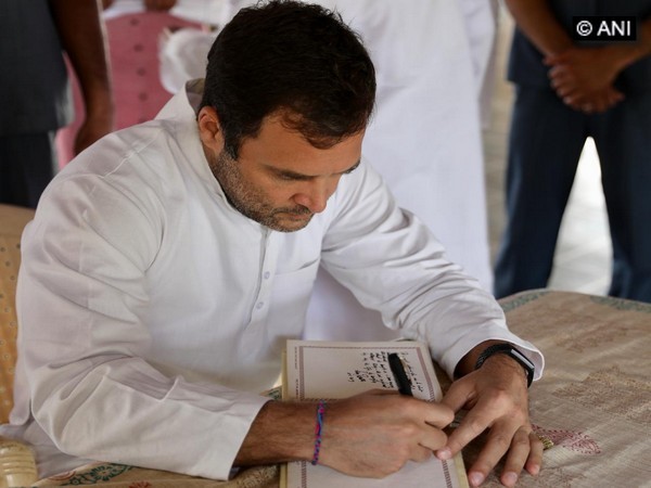 Rahul Gandhi signing the visitor book at Sabarmati Ashram in Gujarat on Tuesday.