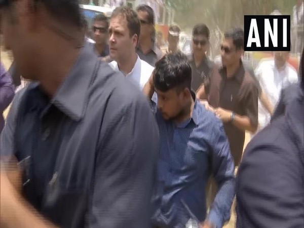 Congress president Rahul Gandhi helps an injured journalist to an ambulance in Wayanad on Thursday.