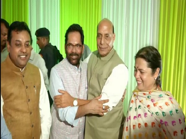 Union Defence Minister along with others at the residence of Union Minority Affairs Minister Mukhtar Abbas Naqvi in New Delhi on Wednesday. Photo/ANI