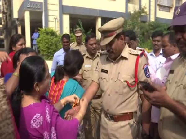 Women tied rakhis on police officer's hands in Telangana on Friday. (Photo/ANI)