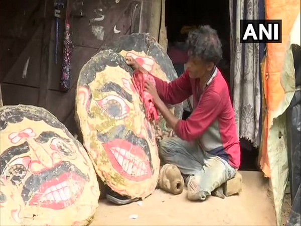 Prakash Bhoi, the artisan, with heads of the effigies on Saturday. photo/ANI