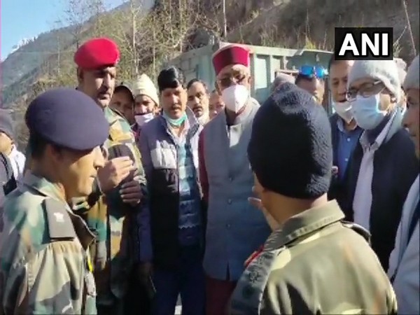 Uttarakhand Chief Minister Trivendra Singh Rawat being briefed on flood situation by Army and ITBP jawans, in Tapovan area of Chamoli district. (Photo/ANI)