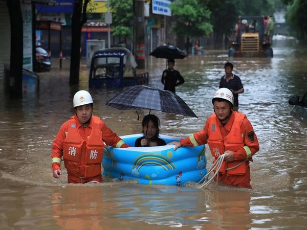 A woman being rescued by emergency workers in China’s Jiangxi province (Photo/Reuters)