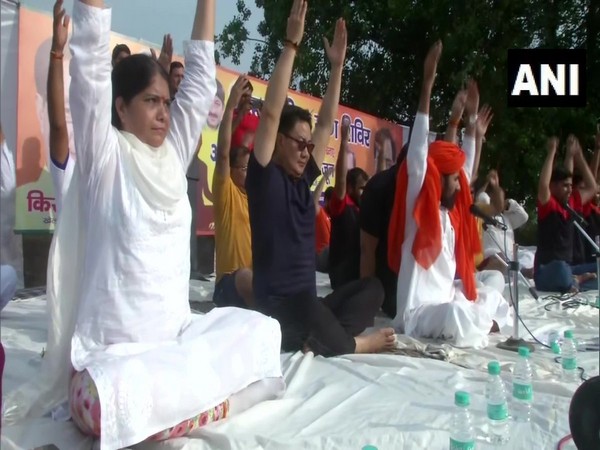 Union Sports Minister Kiren Rijiju performing yoga in New Delhi on Friday. 