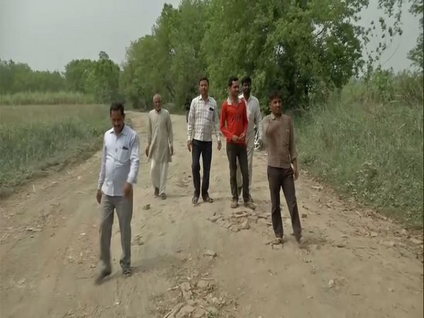 Residents of village Majlis Taufikpur showing bad condition of road connecting their village to other parts of the city