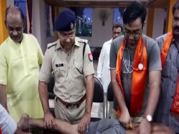 Shamli Superintendent of Police Ajay Kumar tends to Kanwar pilgrims at a medical camp. on Saturday. Photo/ANI 