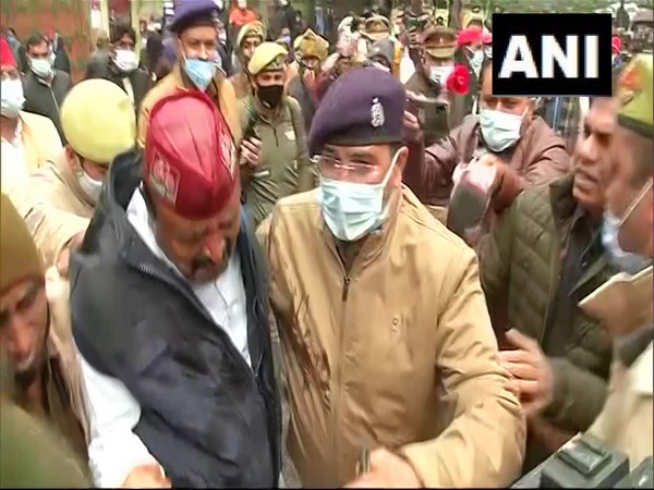 Police taking Samajwadi Party worker Thakur Aditya with them. (ANI/photo)