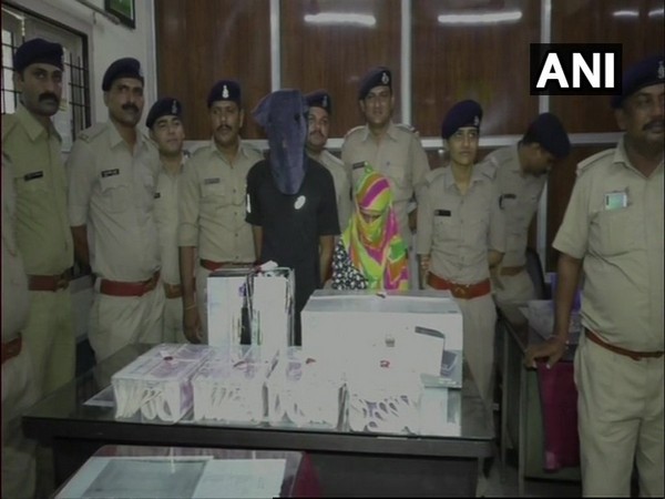 Two arrested persons along with seized fake currency notes in Sachin area of Surat, Gujarat on Saturday.