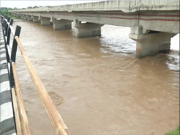 The overflowing Devak river in Samba district. Photo/ANI