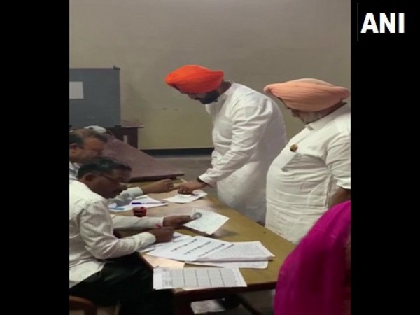 Sandeep Singh (in orange turban) exercising his right to franchise. 