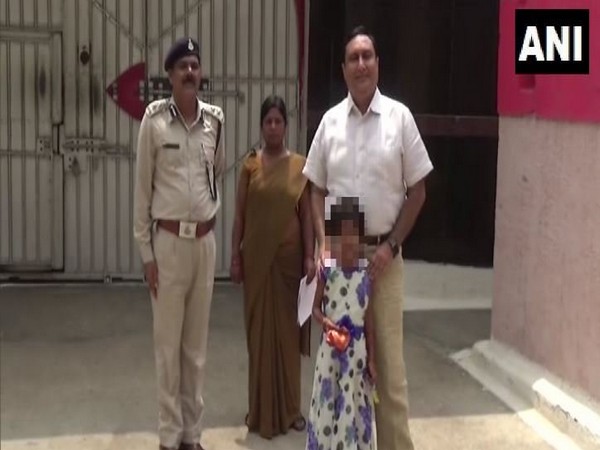 Bilaspur district collector Dr Sanjay Alang with the six-year-old girl who was admitted to a school.