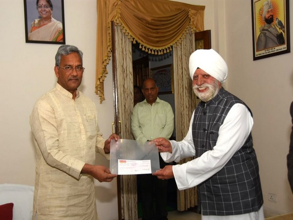Uttarakhand Chief Minister Trivendra Singh Rawat receiving Rs 50 lakh cheque from Sant Nirankari Mandal member Harbhajan Singh on Monday. Photo/ANI