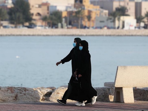 Women wear protective face masks, as they walk, after Saudi Arabia imposed a temporary lock-down on the province of Qatif, following the spread of coronavirus.